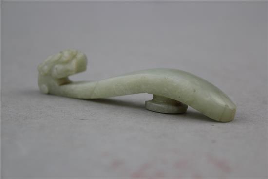A Chinese pale celadon jade belt hook, 19th century, 9.8cm.